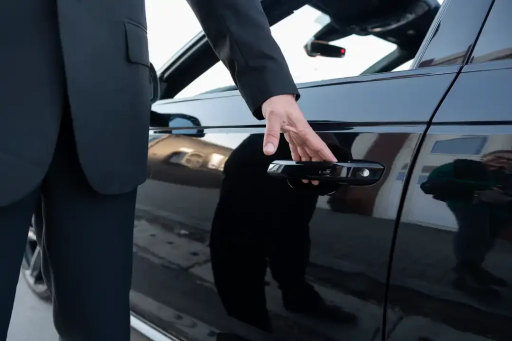 chauffeur opening a car door