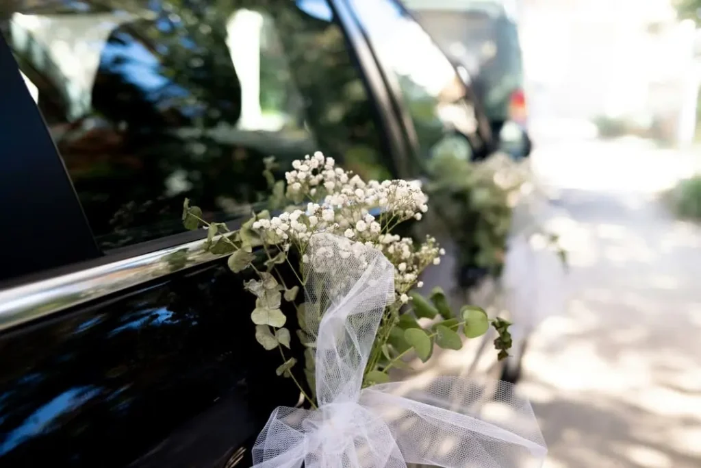 side of a car with flowers for wedding