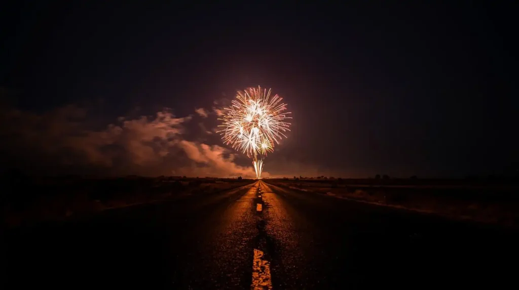 Fireworks in the distance seen from a roadway at night
